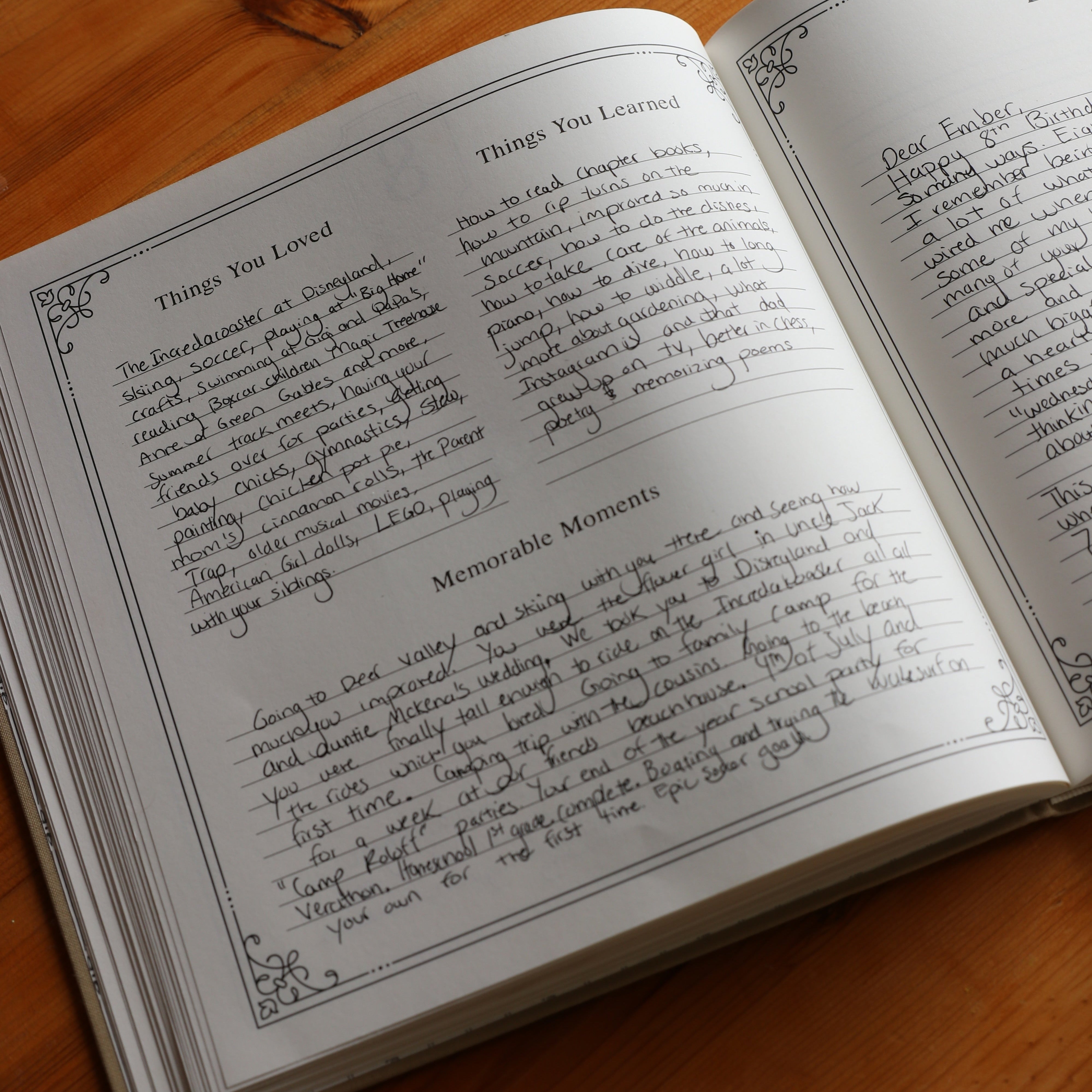 Open book with handwritten text on a wooden surface